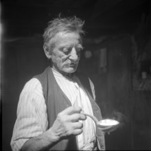 Old farmer eating soup, Lungern 1942.