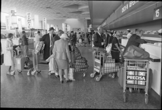 Tourists at airport Zurich-Kloten 1971.