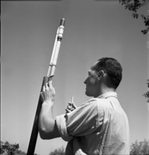 Man with hail defense rockets, 1951.