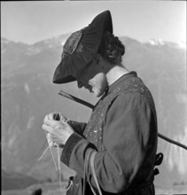 Woman knitting on the Alpine pasture, Valais 1942.