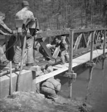 Soldiers constructing footbridge over the Sihl; 1950.