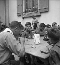 Together at the table with bread and drink.