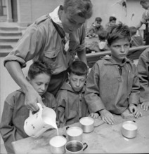 Together at the table with bread and drink.