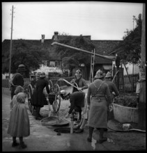 Women of the auxillary fire brigade during an exercise, 1941.