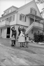 Tibetan refugees waving outside Appenzell house, Waldstatt 1962.