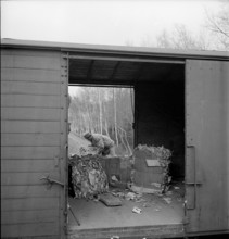 WW 2: economy of war; inmate unloading waste, used paper.