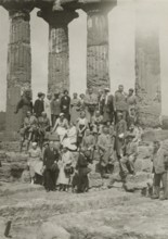 A group of visitors in front of the Temple of the Dioscuri in Agrigento. 1924
