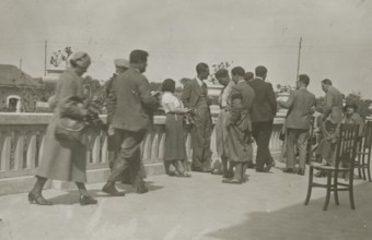 Moment of relaxation on a terrace. 
	
		1924
