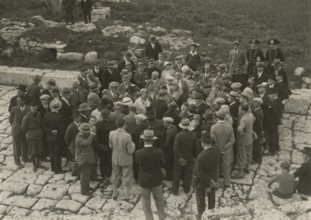 A small group around a guide. 
	
		1924