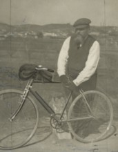 Frederick Johnson next to his bicycle. 
	
		1900-1910