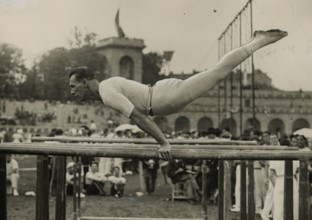 Athlete on the parallel bars at the Arena Civica in Milan.