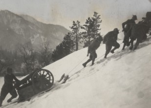 Soldiers tow a piece of heavy artillery through the snow