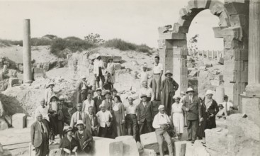 Excursionists in front of Trajan's Arch in Leptis Magna. 
	
		1931