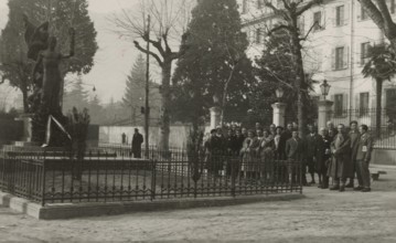 Members of the Touring Club Italiano  in front of the war memorial in Domodossola. 
	
		1931