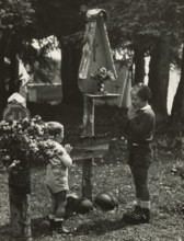 Touring Club campsite at the Pale di San Martino: two children at the camp altar. 1951