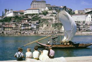 A series of images about port wine production in Portugal c 1960 - traditional rabelo boat with oak