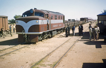 Commonwealth Railways diesel engine train with freight wagons and passenger carriages, Alice