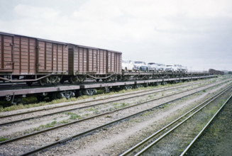 Railway train freight wagons and cars being transported by train piggyback transporter, Australia