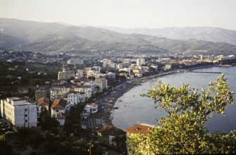 View over beach and buildings, Diano Marina, Imperia, Liguria, Italy, July 1959.