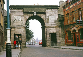 Bishop's Gate part of the old city walls built 1789, and The Arch Bar pub, Derry Londonderry,