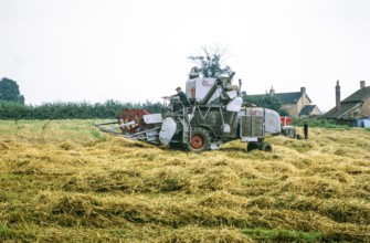 Claas combine harvester harvesting in field   England, UK 1968.