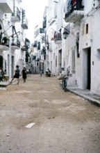Whitewashed buildings and unmade dirt street in Ibiza town, Ibiza, Balearic Islands, Spain 1967.