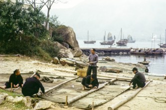 People on beach repairing their junk boat sail, Castle Peak, New Territories, Hong Kong, Asia, 1964