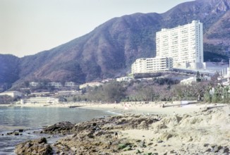 Skyscraper flats from beach in front of Repulse Bay Hotel, Repulse Bay, Hong Kong, Asia 1964.