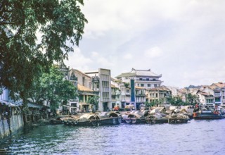 Waterfront quayside with sampan boats, Singapore River, Singapore, southeast Asia c 1963.