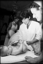 Mother changing baby's nappies, 1969