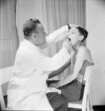 Boy undergoing physical examination by doctor, Zurich 1947