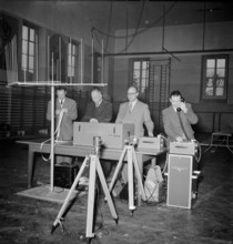 Longines technicians test the apparatus for time recording with Chronocamera, 1950