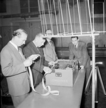 Longines technicians test the apparatus for time recording with Chronocamera, 1950