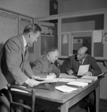 Census form control at the police station, Cully 1950