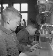 Boys cleaning their teeth in a school dentistry ambulatory, around 1955
