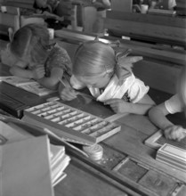 Girls doing writing exercice, letter case,  Dicken 1940