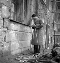 Man checking structural fabric of a building in Geneva 1943