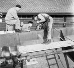 Preparation of overland ship transpor, cutting hull in two with blowtorch, 1946
