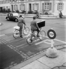 bicyclist waiting at crossroad, Basle 1948