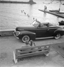 Couple with convertible at the Limmat, Zurich 1947