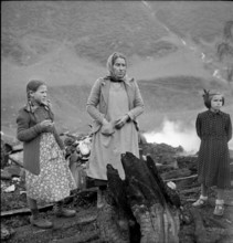 Selva completely burned down, woman and girl watching the remains of their household 1949