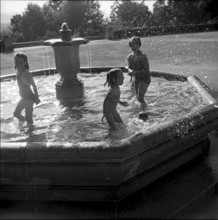 Children cooling in a fountain, Zurich 1952