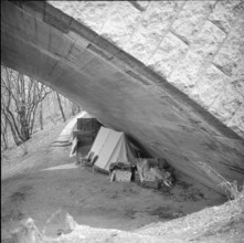 Unsuccessful flat hunting person camping under a bridge in Genevy 1962