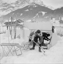 14th Swiss New Year's tent camp in Les Diablerets 1957: shoveling snow