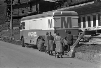 Customers waiting near Migros van, truck in Sarreyer VS, 1972