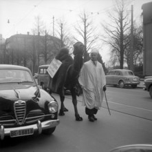 Placard advertising oriental carpet sale upon a camel in Berne 1956