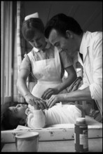 Man changing baby's nappies, 1969
