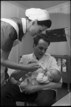Man feeding a baby, 1969