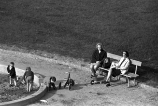 Women looking after children on a playground in Geneva 1966
