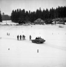 Skiers pulled by a snowmobile, St. Cergue 1961